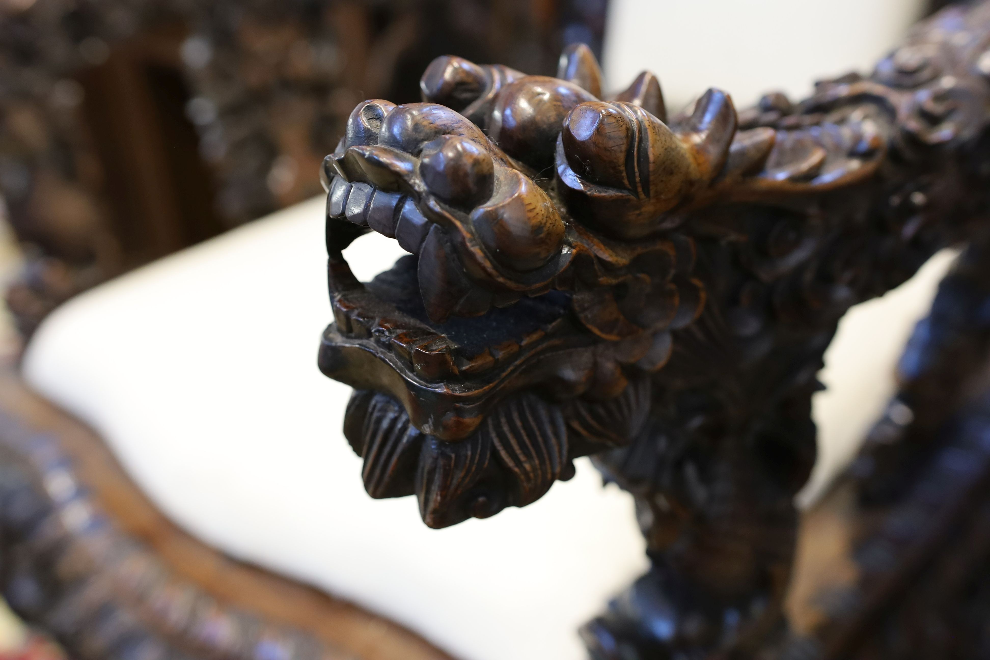 A good Chinese hardwood ‘dragon’ throne armchair, c.1900, 114.5cm high, 68cm wide at the arms